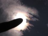 my index finger and iridescent clouds
