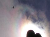 A Plane under Iridescent Clouds