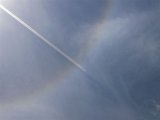 22-degree Halo and a vapor trail like an arrow